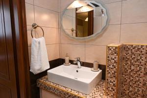 a bathroom with a white sink and a mirror at Calm Breeze House in Nea Peramos +46 photos