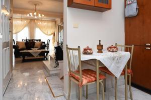 a dining room with a table and chairs and a living room at Calm Breeze House in Nea Peramos