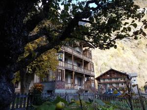 a large building with a tree in front of it at Casa Smitt in Alagna Valsesia