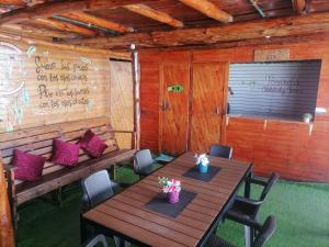 a dining room with tables and chairs in a cabin at Chiki luki in Playa Blanca