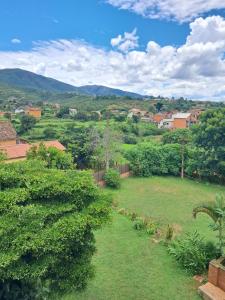 a view of a field of grass with trees and houses at Hotel Anjara in Ambositra