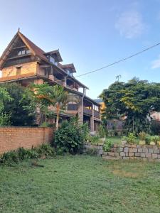 a large house with a yard in front of it at Hotel Anjara in Ambositra