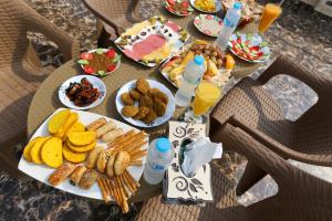 a table with plates of food and drinks on it at Grand pyramids view & Jacuzii in Cairo