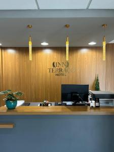 an office with a sign on a wooden wall at INN TERRAÇO Hotel in Mirandópolis