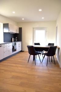 a kitchen and dining room with a table and chairs at Ferienwohnung Bahnblick - Stilvoll in bester Lage - als Wohnung oder Haus in Olbersdorf