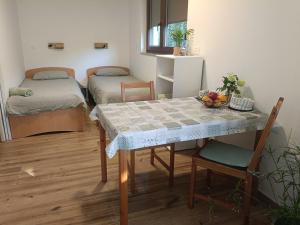 a small room with a table and a bed at Gravitacija East in Tolmin