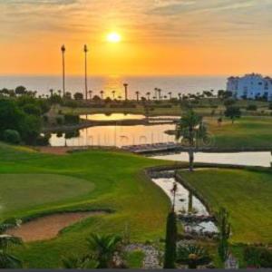 a view of a golf course at sunset at Chez Charifa in Asilah