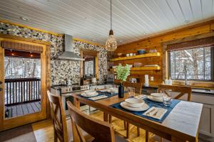 a kitchen with a large wooden table with chairs at Freedom Creek Hideaway-Veteran Host-Pet Friendly-Single nights-Newly Renovated!! in Pigeon Forge +35 photos