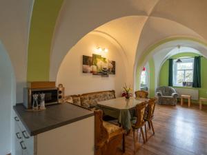 a kitchen and living room with a table and chairs at Ferienwohnung Reichel in Remptendorf