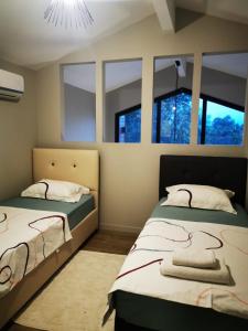 two beds in a room with windows at Villa Rüzgar in Dalaman +9 photos