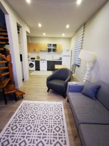 a living room with a couch and a kitchen at Villa Rüzgar in Dalaman