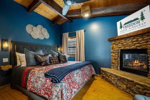 a bedroom with a bed and a fireplace at Freedom Creek Hideaway-Veteran Host-Pet Friendly-Single nights-Newly Renovated!! in Pigeon Forge