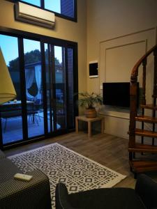 a living room with a couch and a television at Villa Rüzgar in Dalaman