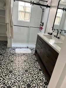 a bathroom with a sink and a shower at Northwood Revival in West Palm Beach +6 photos