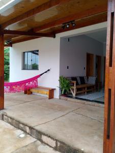 a patio with a hammock in a house at Área de Lazer Portal da Canastra in Delfinópolis