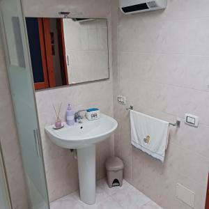 a bathroom with a sink and a mirror at Sole in Quartu Sant'Elena