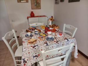 a table with a table cloth with food on it at Sole in Quartu Sant'Elena