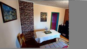 a room with a table and a brick wall at Apartman Bogatić 2 in Bogatić