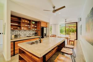 a kitchen with a sink and a counter top at Private Jungle House No1Calalu with AC, Pool & EV in Talamanca