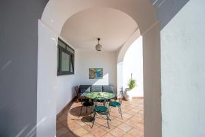 a hallway with a table and chairs in a house at Casa Marina in Praiano