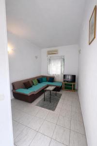 a living room with a couch and a table at Apartments Zenit in Kotor