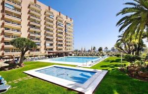 a large apartment building with a large swimming pool at Hotel PYR, Spacious Studio with a Big Terrace in Fuengirola