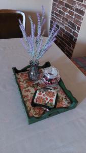 a tray with a vase on top of a table at Apartman Bogatić 2 in Bogatić