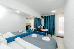 two beds in a room with blue and white at ERA Studios Chisinau in Chişinău