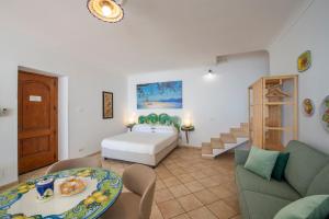 a living room with a bed and a couch at Casa Marina in Praiano