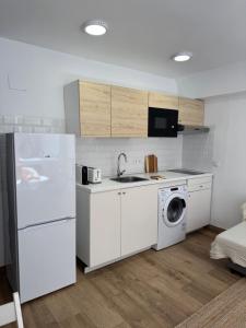 a kitchen with a white refrigerator and a washing machine at Ideal parejas Estudio Granadella en Jávea in Platja de l'Arenal +10 photos