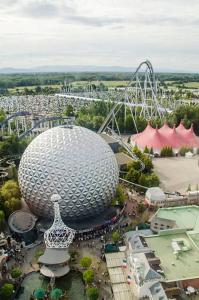 an amusement park with a large ball and a roller coaster at La parenthèse in Artolsheim