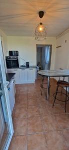 a kitchen with a table and a counter top at Appartement St montan in Saint-Montan +3 photos