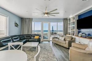 a living room with a couch and a tv at 477 Fort Pickens Rd. in Pensacola Beach
