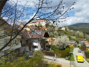 a view of a town with a yellow car on a street at Hotel Prechtlhof in Althofen