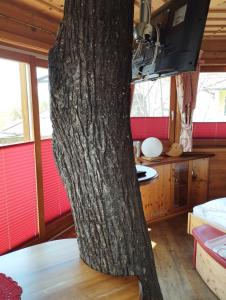 a tree trunk in a room with a table at Hotel Prechtlhof in Althofen