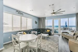 a living room with a couch and a table and chairs at 477 Fort Pickens Rd. in Pensacola Beach