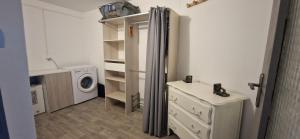 a laundry room with a washing machine and a washer and dryer at Appartement St montan in Saint-Montan