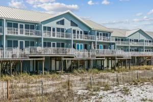 a row of houses on the beach at 477 Fort Pickens Rd. in Pensacola Beach