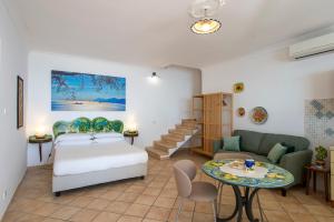 a bedroom with a bed and a couch and a table at Casa Marina in Praiano +9 photos