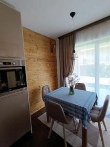 a kitchen with a table with a blue table cloth at Apartman Milekic in Mrkonjić Grad