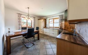a kitchen with a wooden table and a dining room at Haus Lara - Fewo 2 in Wallgau