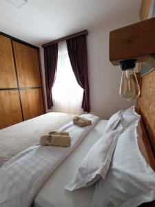 a bedroom with a bed with two towels on it at Apartman Milekic in Mrkonjić Grad