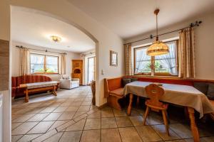 a living room with a table and a couch at Haus Lara - Fewo 1 in Wallgau