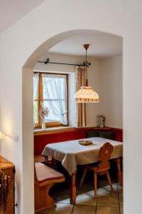 a dining room with a table and a window at Haus Lara - Fewo 1 in Wallgau