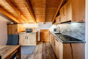 a kitchen with wooden cabinets and a sink at Haus Lara - Fewo 3 in Wallgau