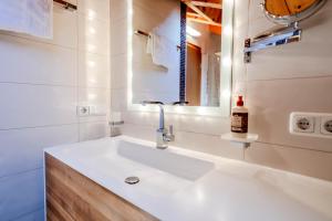 a bathroom with a white sink and a mirror at Haus Lara - Fewo 3 in Wallgau