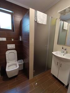 a bathroom with a toilet and a sink and a shower at Apartman Milekic in Mrkonjić Grad +14 photos