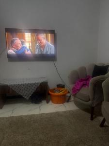 a flat screen tv hanging on a wall in a living room at The sun Pyramids View in Cairo