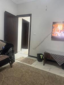 a living room with a couch and a picture on the wall at The sun Pyramids View in Cairo