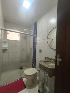 a bathroom with a toilet and a sink and a shower at Morada Vermelha in Vitória da Conquista